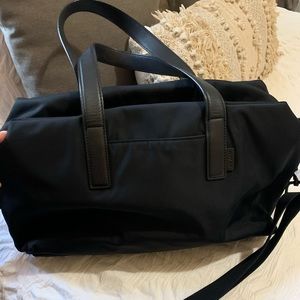 The original everywhere bag barely used. Has one minor stain in the front pocket